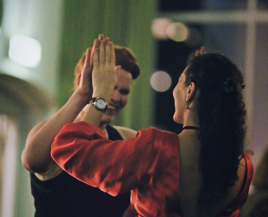 Two dancers giving eachother positive feedback